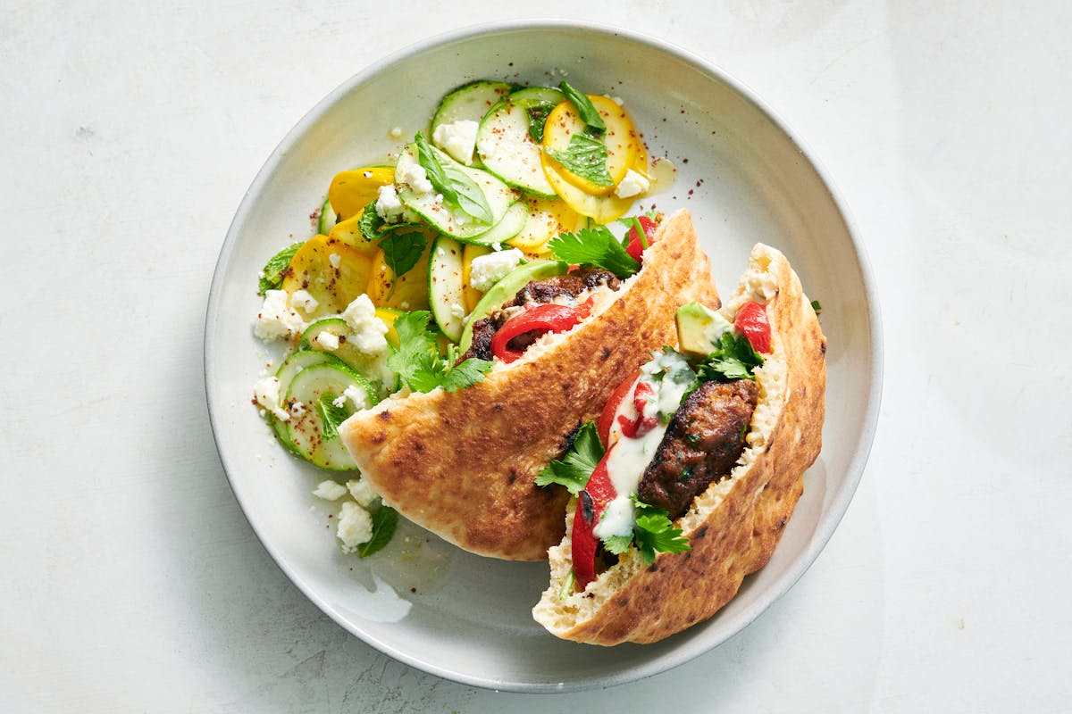 A zucchini salad is a fresh, light pairing to a bright, garlicky lamb burger in this simple summer menu. Food styled by Simon Andrews.