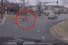 A driver's dashcam video captured the moment when a 2-year-old girl strapped in her car seat tumbled onto the street from her mother's car.