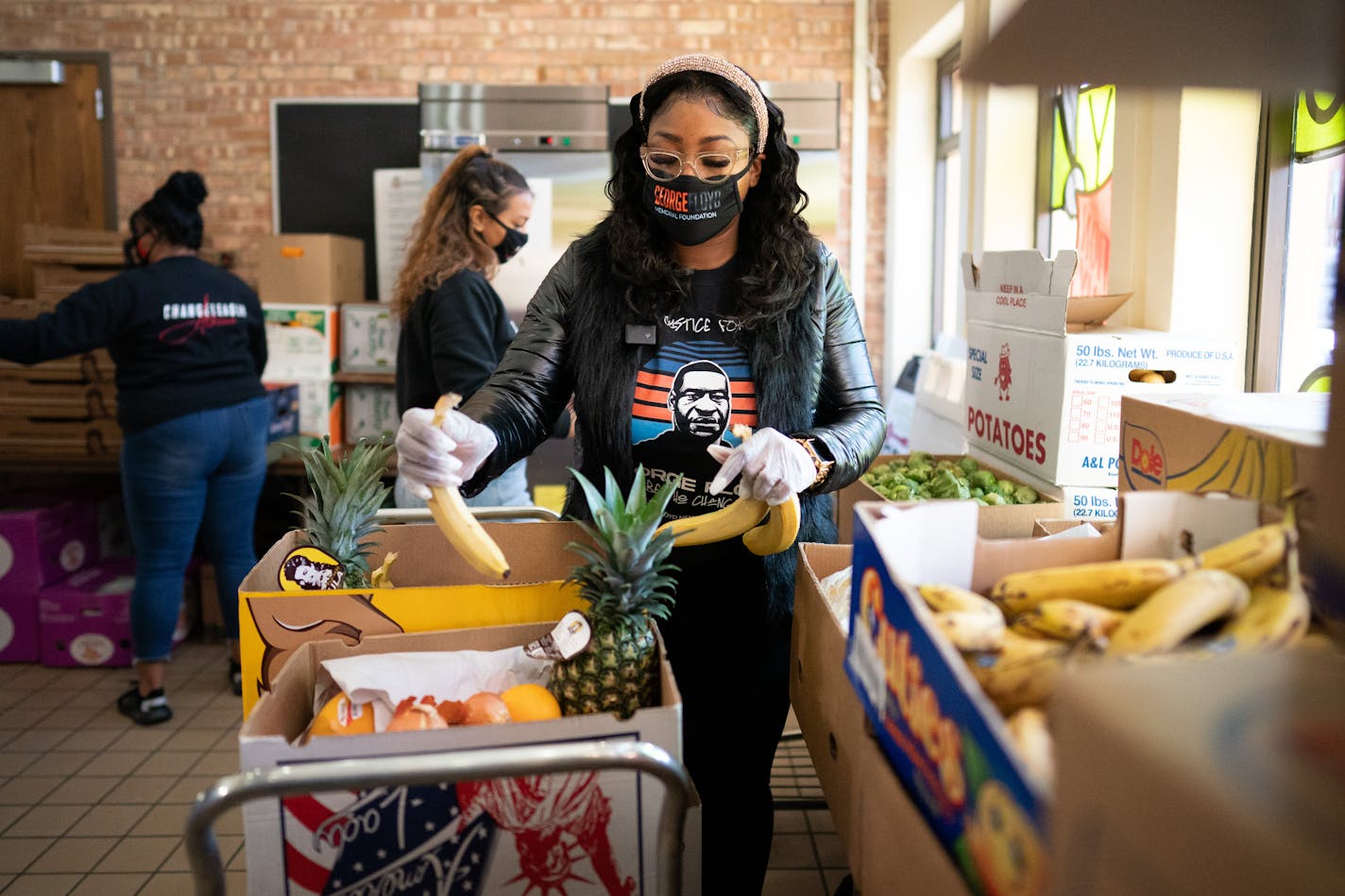 Bridgett Floyd helped pack produce boxes.