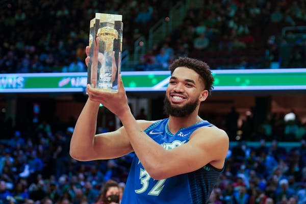 The Timberwolves' Karl-Anthony Towns holds up the trophy after winning the three-point contest Saturday, part of the skills challenge competition of N