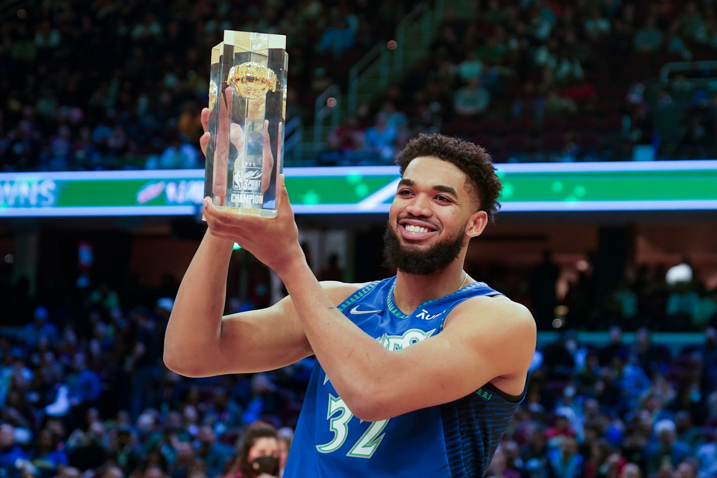 The Timberwolves' Karl-Anthony Towns holds up the trophy after winning the three-point contest Saturday, part of the skills challenge competition of NBA All-Star weekend