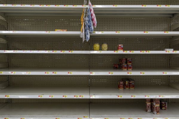Near-empty shelves of canned foods at a WalMart store in Port St. Lucie, Fla., on Thursday. Minnesotans with homes or businesses in Florida are among 