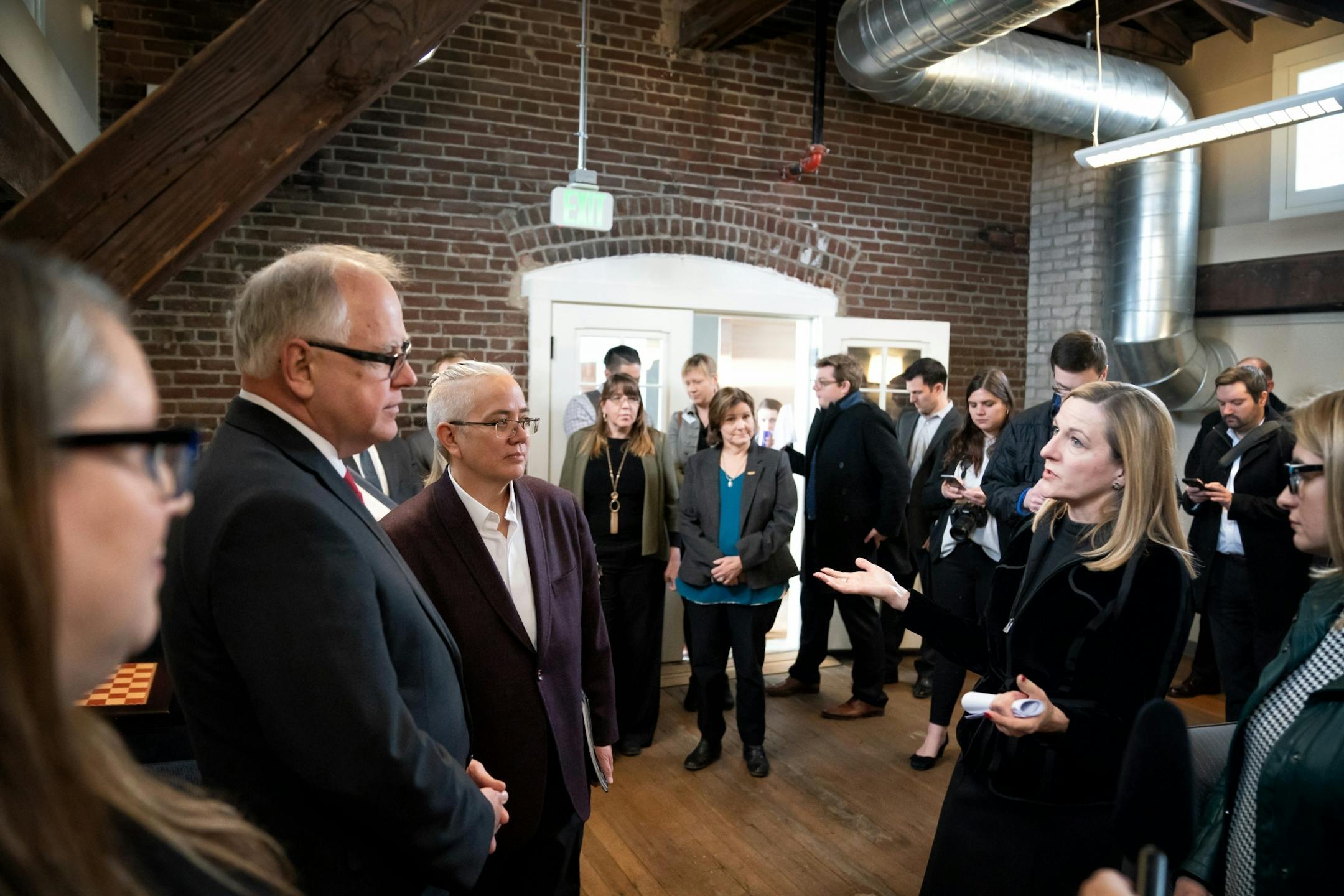 Accompanied by Housing Commissioner Jennifer Ho, left, and Deidre Schmidt President & CEO of CommonBond Communities, right, Governor Tim Walz toured the Upper Post Veterans Community at Fort Snelling, remodeled as a place to live for formerly homeless veterans. He touted it as an example of important and appropriate investments in Minnesota as he released his $1.3 billion bonding proposal.