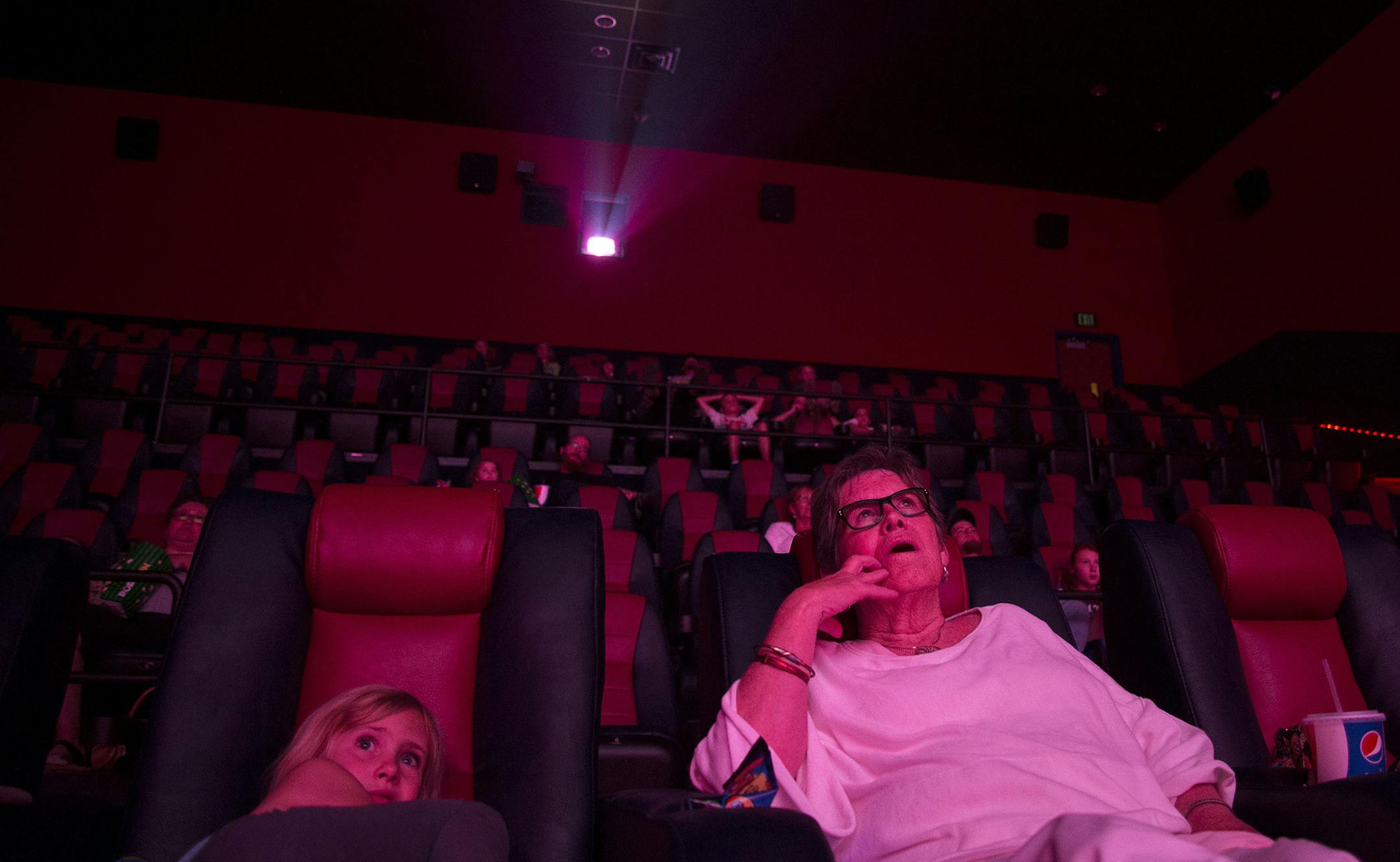 From left, Kathryn Hallstein, 6, of Hanover, watched "Minions" with her great aunt Tricia Olson, of Arizona, in the new reclining chairs at St. Michael Cinema in St. Michael, Minn., on Friday July 10, 2015. The St. Michael Cinema recently re-opened under new ownership and features an IMAX screen, reclining seats, self-service soda machines and a sit-down restaurant. ] RACHEL WOOLF &#xb7; rachel.woolf@startribune.com