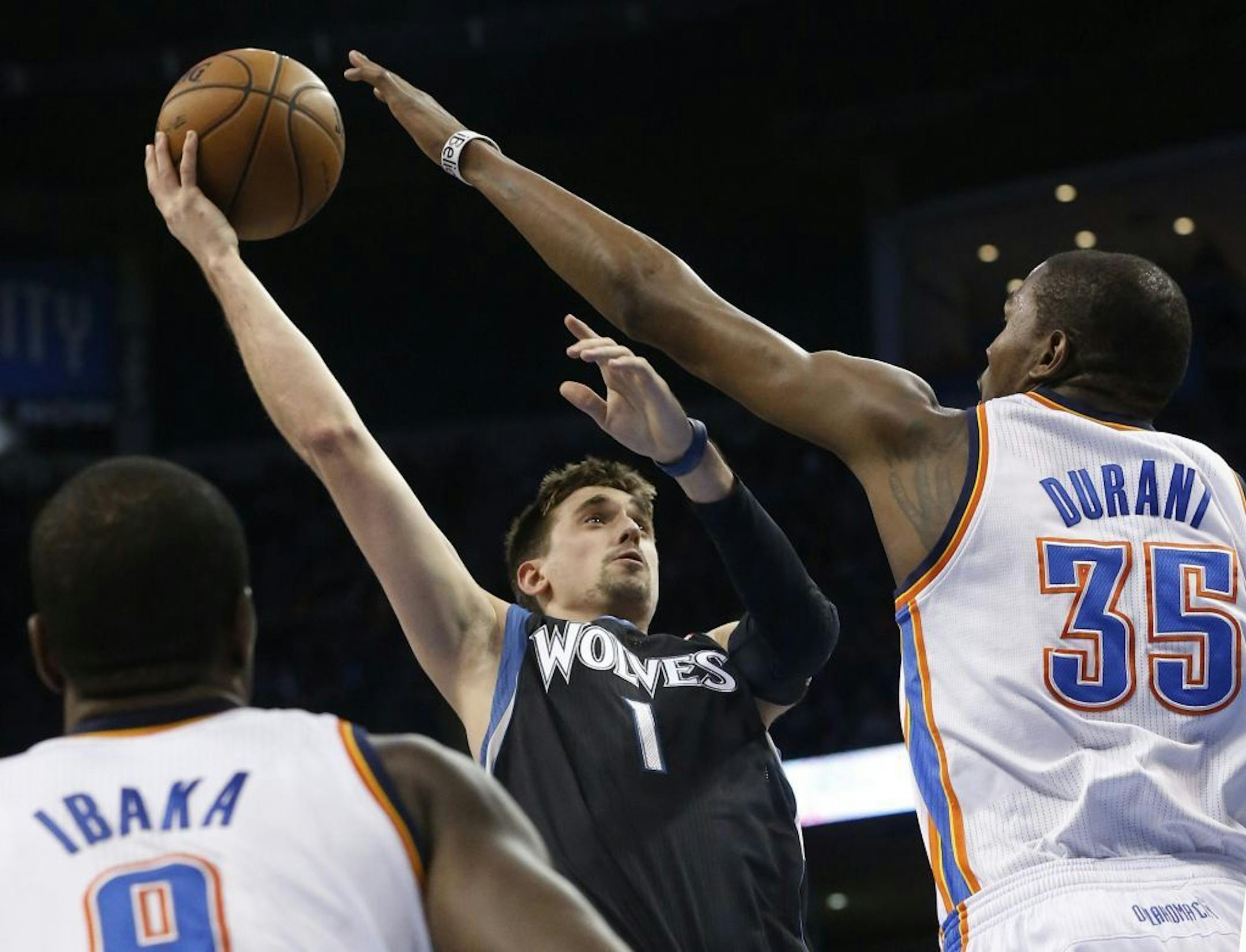 Timberwolves guard Alexey Shved shoots as Oklahoma City Thunder forward Kevin Durant defends.