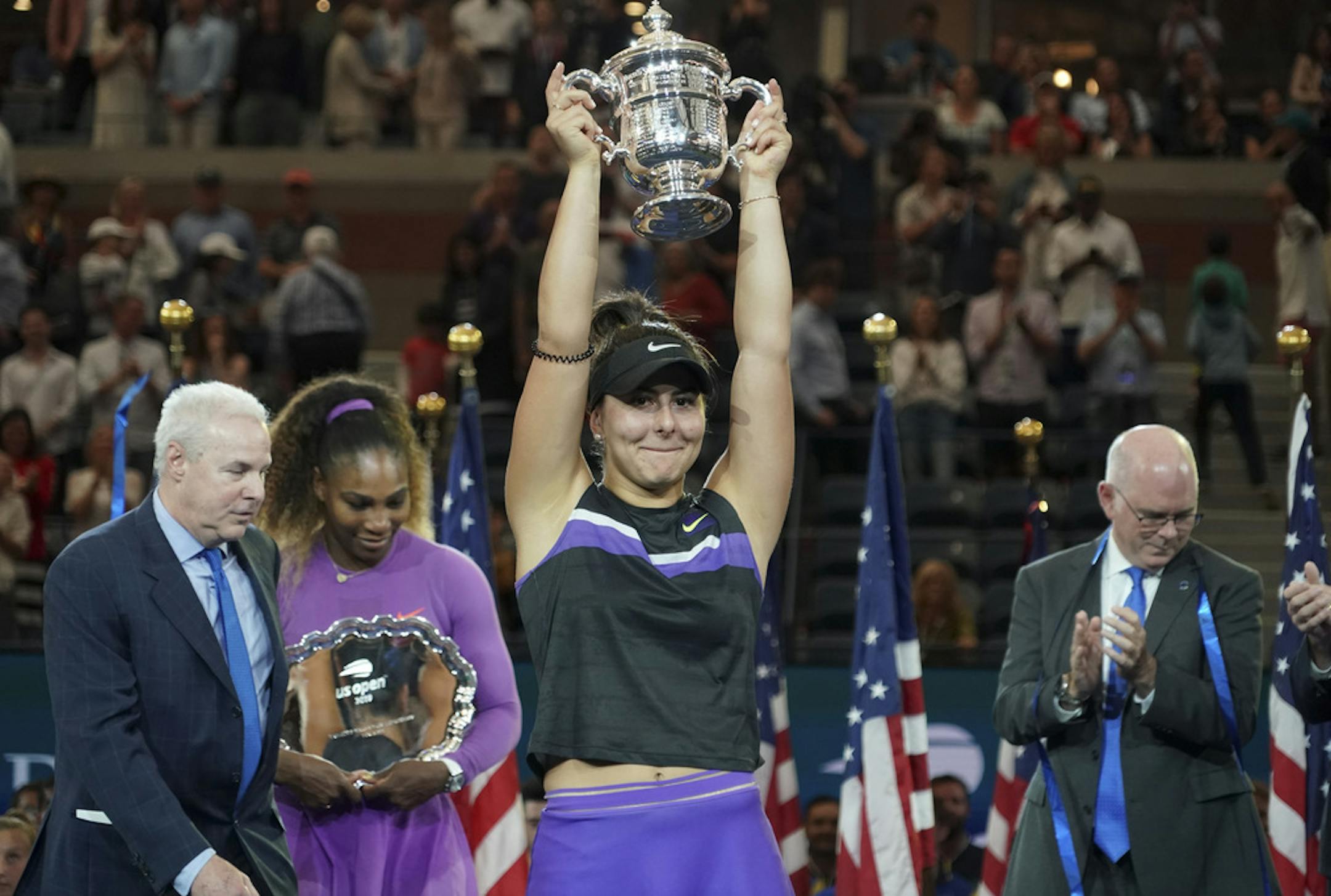 Bianca Andreescu of Canada during the trophy ceremony after defeating Serena Williams of the U.S., second from left, in the women's singles final during the U.S. Open at Arthur Ashe Stadium, in New York, Sept. 7, 2019. Andreescu defeated Williams, 6-3, 7-5, to win her first Grand Slam title, denying Williams her 24th. (Chang W. Lee/The New York Times)