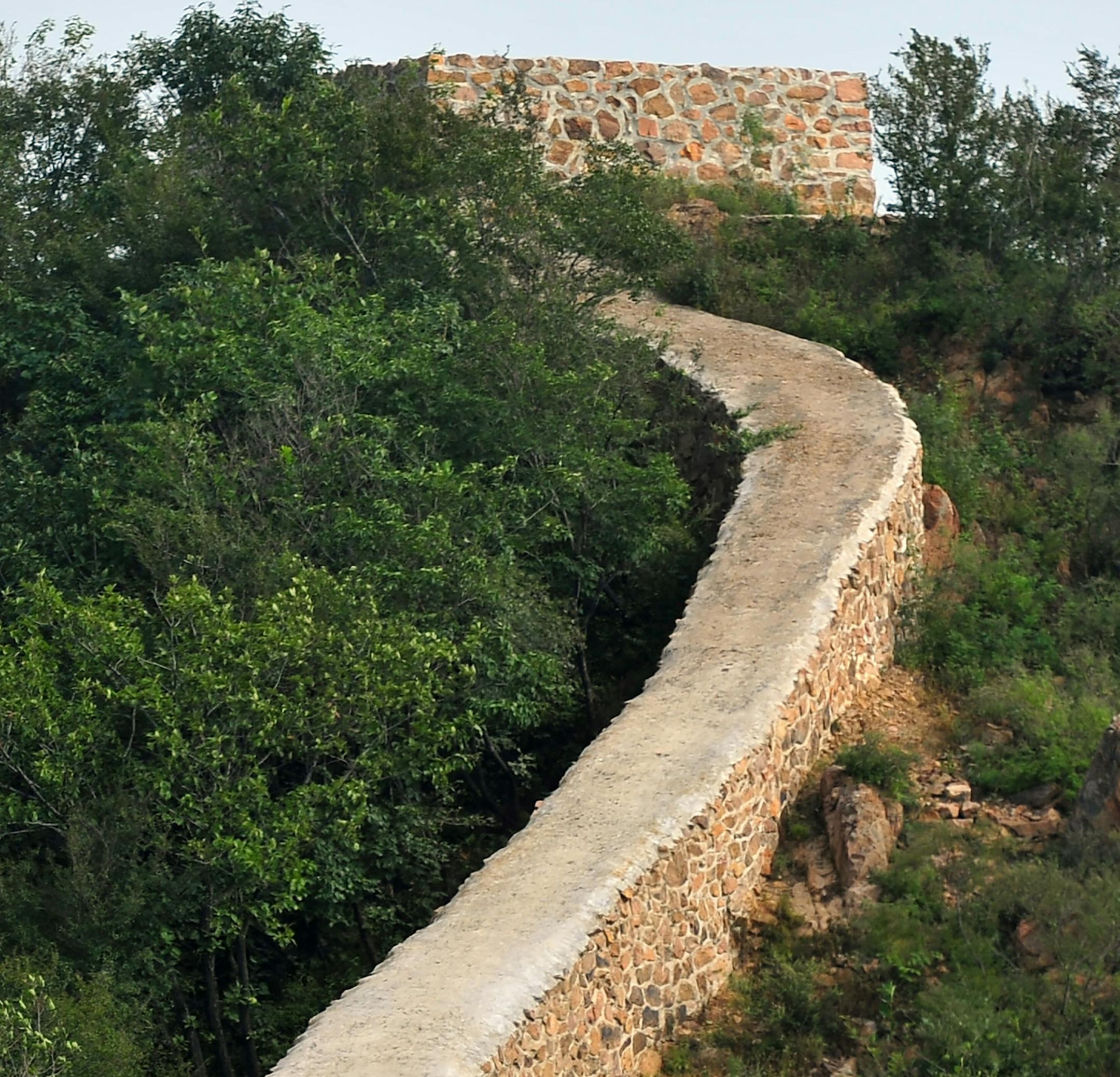 In this Wednesday, Sept. 21, 2016 photo, a restored section of the Great Wall is seen in Suizhong County in northeastern China's Liaoning Province. Chinese officials are being pilloried over the smoothing-over of a crumbling but much-loved 700-year-old section of the Great Wall of China - a UNESCO World Heritage Site - in the name of restoration. (Chinatopix via AP)