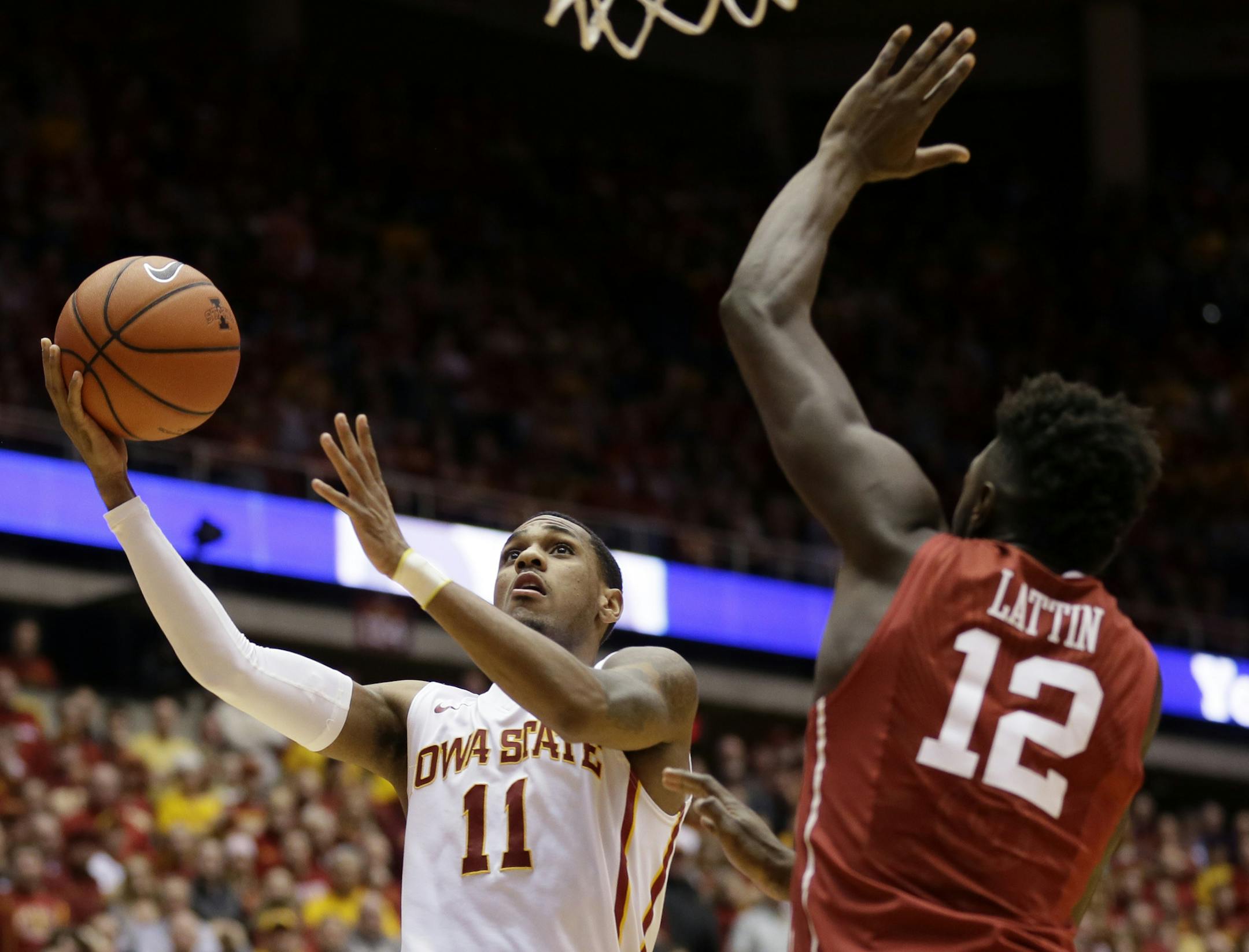 Iowa State guard Monte Morris drives to the basket past Oklahoma forward Khadeem Lattin, right, during the second half of an NCAA college basketball game, Monday, Jan. 18, 2016, in Ames, Iowa. Iowa State won 82-77. (AP Photo/Charlie Neibergall)