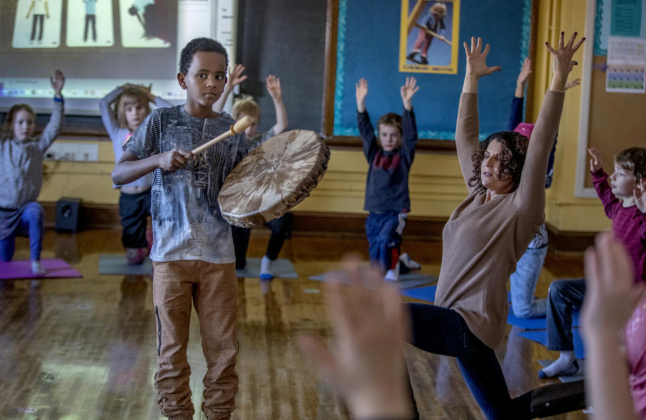 Pratt Community School third-grader Fahim Abdurhamn, cq, gently beat on a drum as he and his class learned yoga instruction known as "yoga calm" from social worker/therapist Kathy Flaminio during a class, Wednesday, January 31, 2018 in Minneapolis, MN. ] ELIZABETH FLORES &#xef; liz.flores@startribune.com