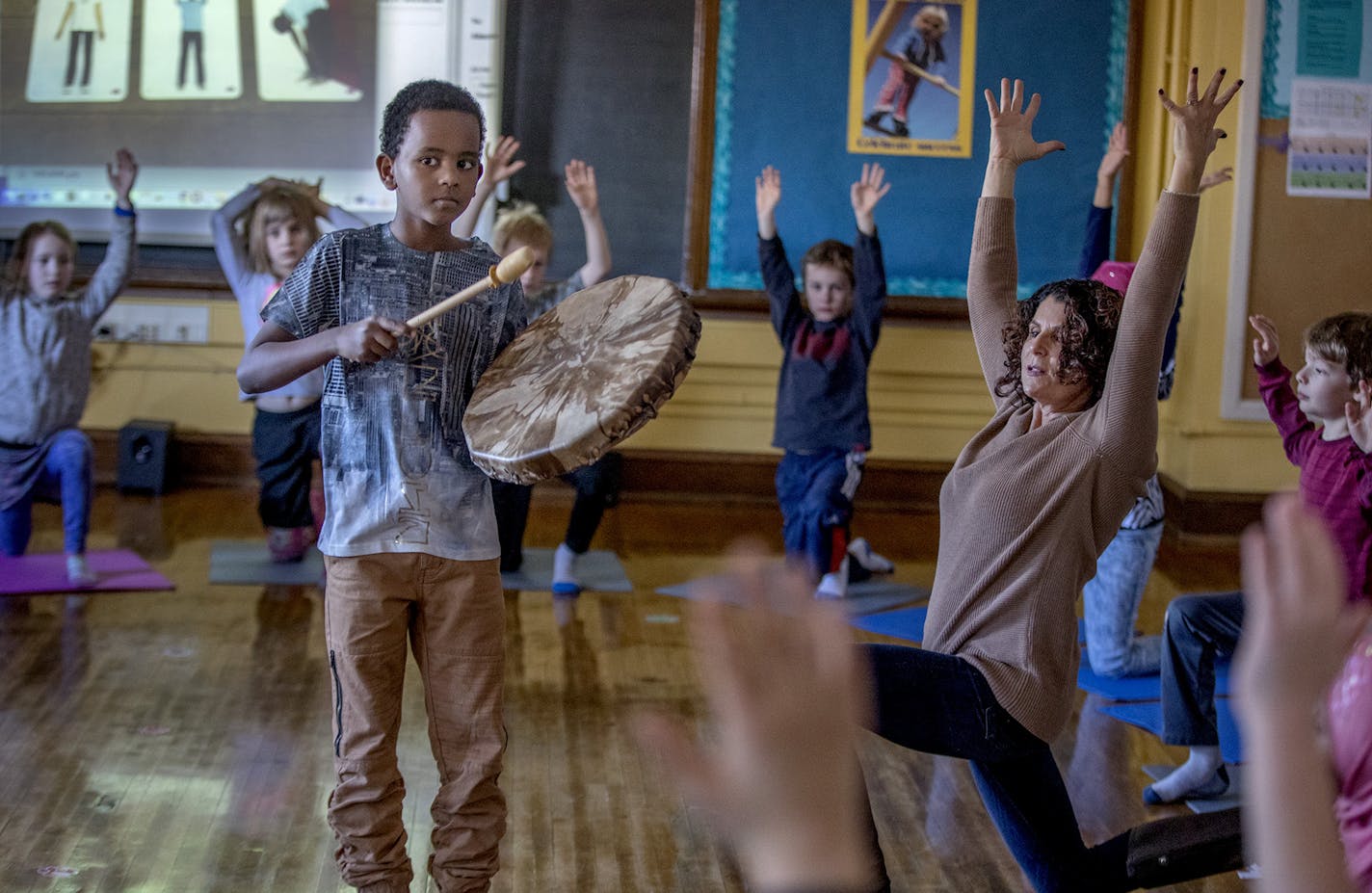 Pratt Community School third-grader Fahim Abdurhamn, cq, gently beat on a drum as he and his class learned yoga instruction known as "yoga calm" from social worker/therapist Kathy Flaminio during a class, Wednesday, January 31, 2018 in Minneapolis, MN. ] ELIZABETH FLORES &#xef; liz.flores@startribune.com