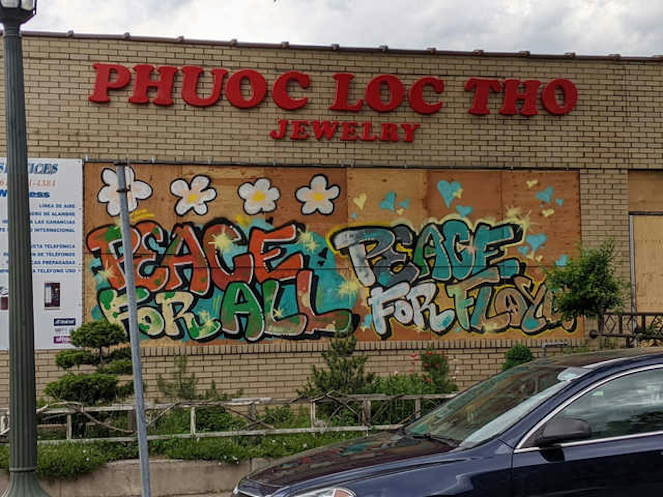 The exterior of Phuoc-Loc-Tho Jewelry at 2515 Nicollet Ave, Minneapolis, is covered in words of healing and hope, just one of the hundreds of murals covering boarded-up businesses around the Twin Cities.