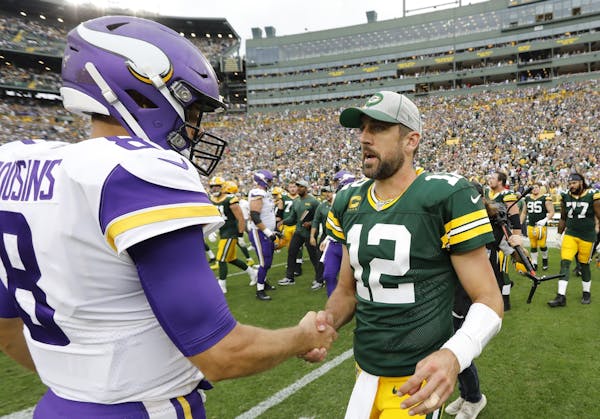 Green Bay Packers' Aaron Rodgers talks to Minnesota Vikings' Kirk Cousins after an NFL football game Sunday, Sept. 15, 2019, in Green Bay, Wis. The Pa