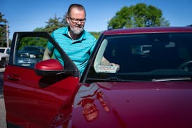 Steve Kull preps his vehicle Wednesday for a day of rideshare driving in Fridley. Kull has been driving nearly a year for Lyft, Uber and now Minnesota