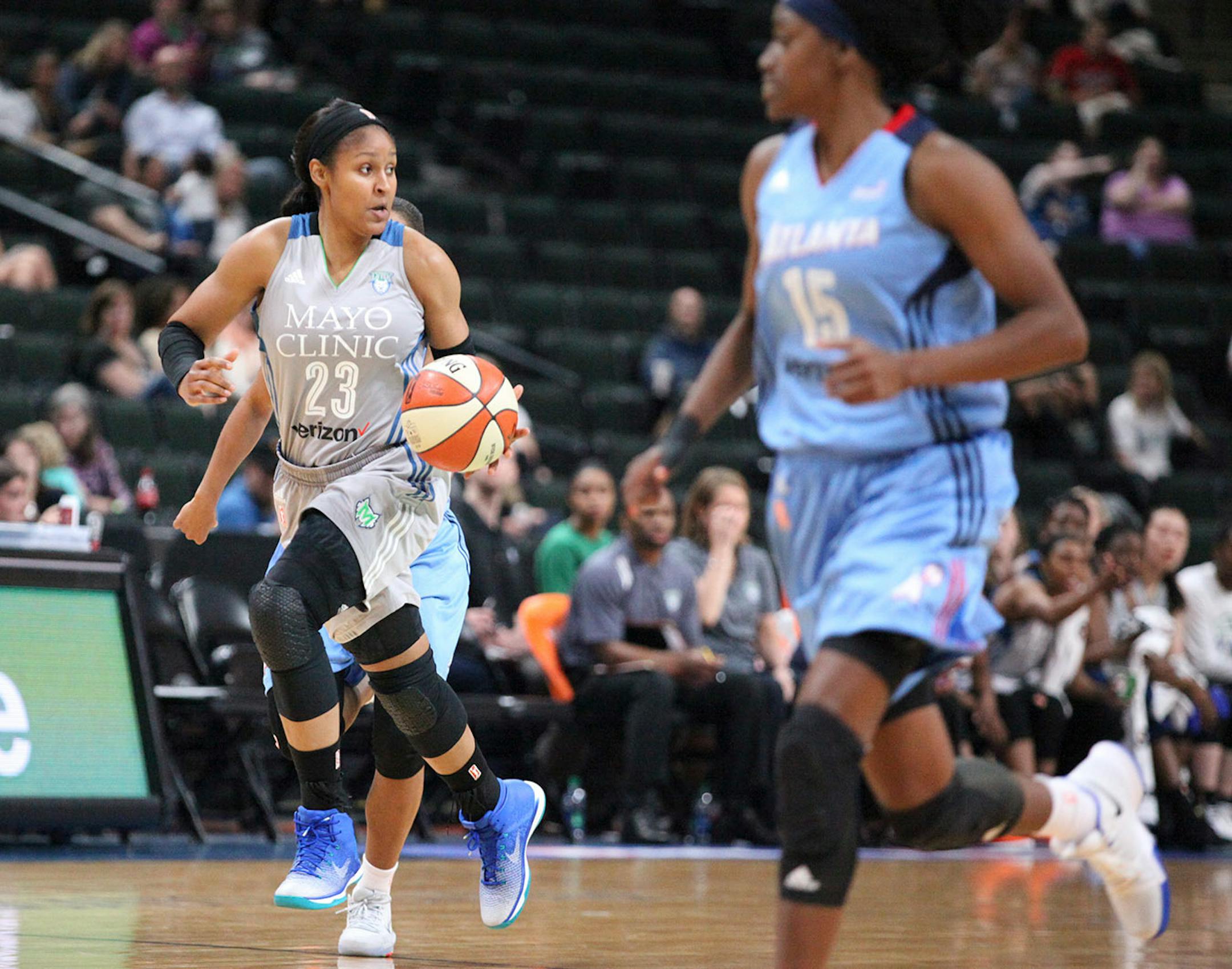 Minnesota Lynx forward Maya Moore (23) pushes the ball up the court in the first period.