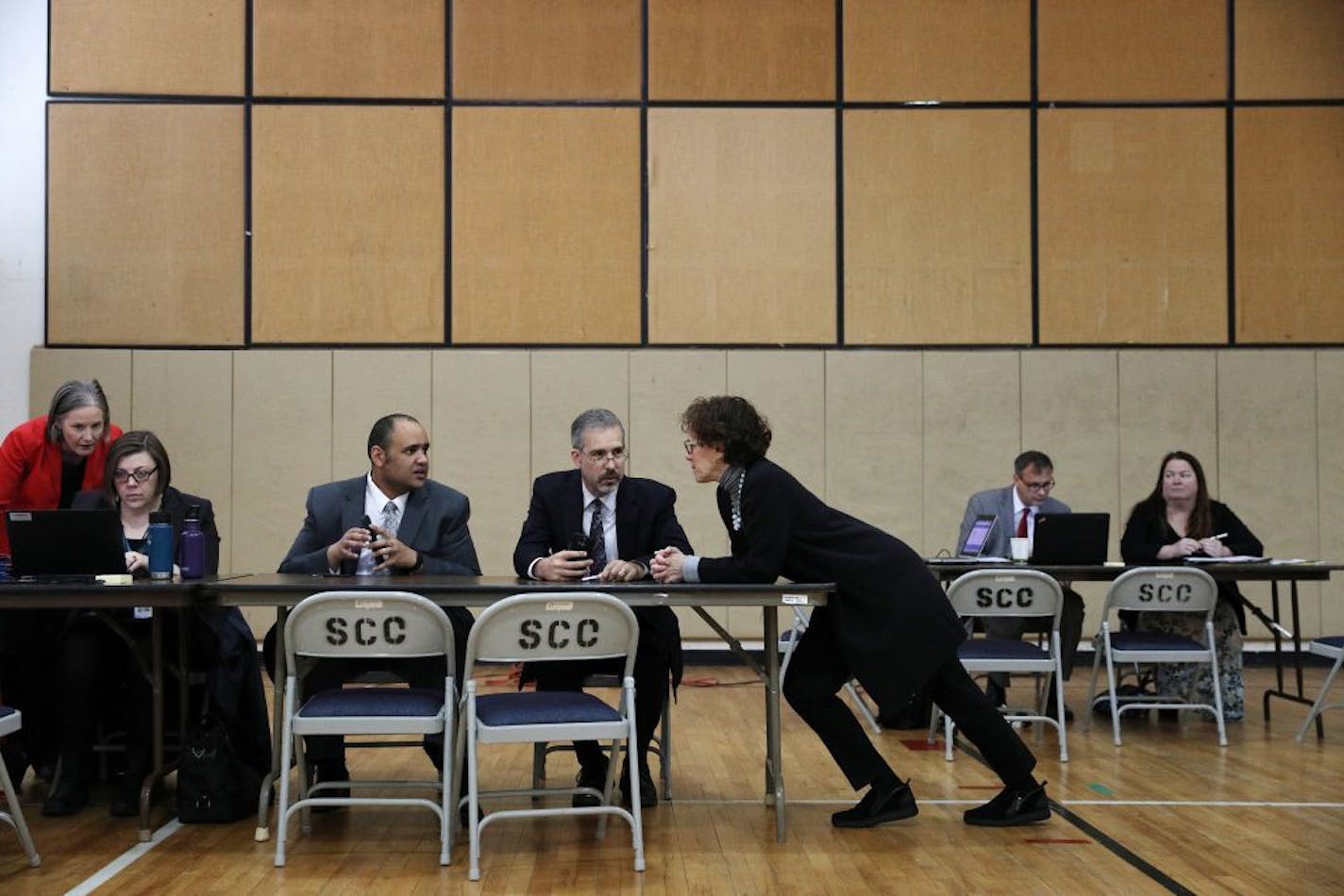 Minneapolis city attorney Susan Segal, center, talked with assistant city attorney Christopher Bates and supervising attorney Timothy Richards as they and other staff members waited to talk with clients and public defenders during the Warrant Forgiveness Day event.