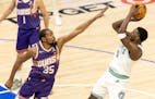 Anthony Edwards scores while being defended by Kevin Durant during Game 2 of the Wolves-Suns series.