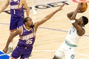 Anthony Edwards scores while being defended by Kevin Durant during Game 2 of the Wolves-Suns series.