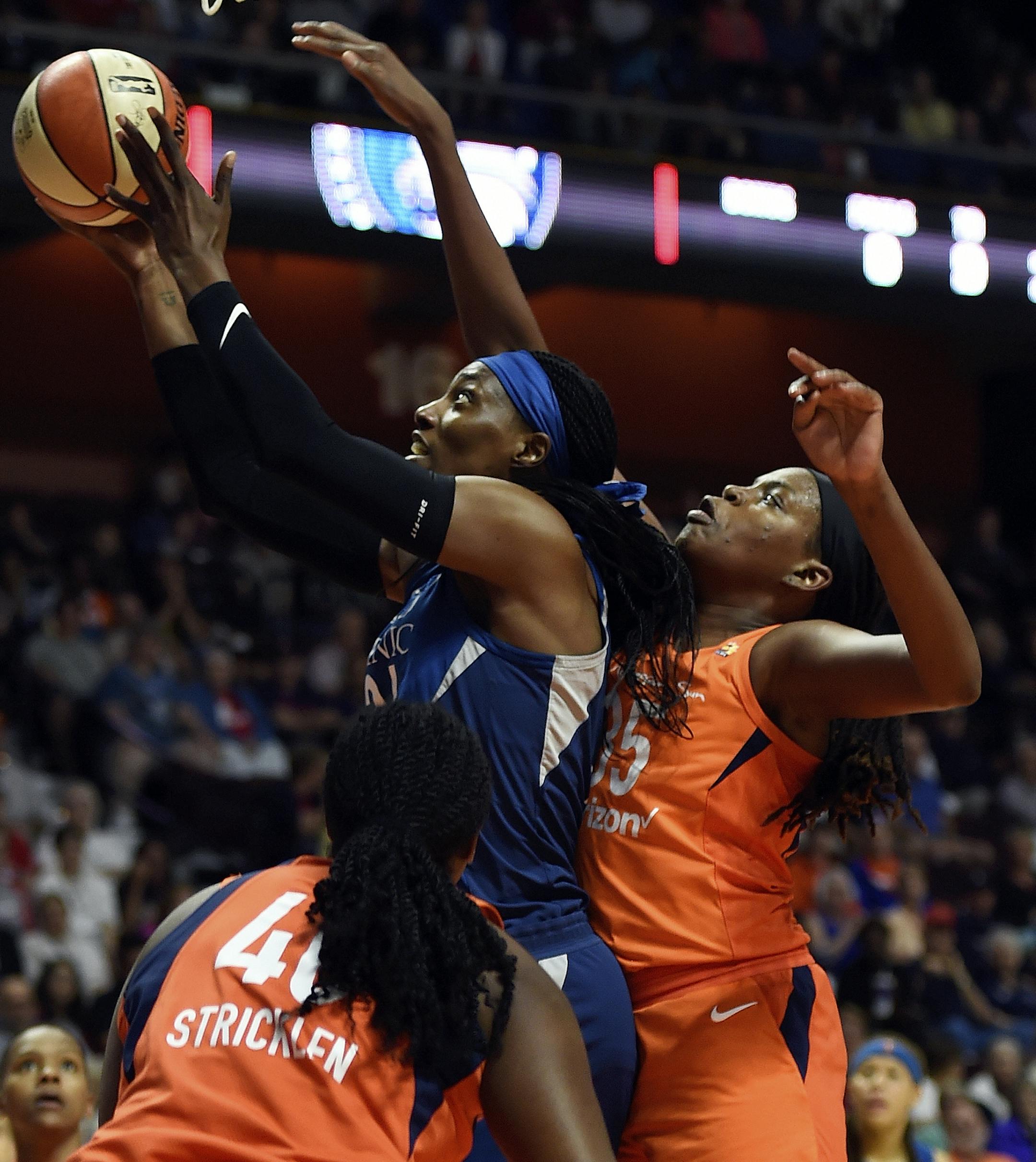 Minnesota Lynx center Sylvia Fowles scores over the defense of Connecticut Sun center Jonquel Jones, right, and Shekinna Stricklen during the second half of a WNBA basketball game Friday, Aug. 17, 2018, in Uncasville, Conn. (Sean D. Elliot/The Day via AP)