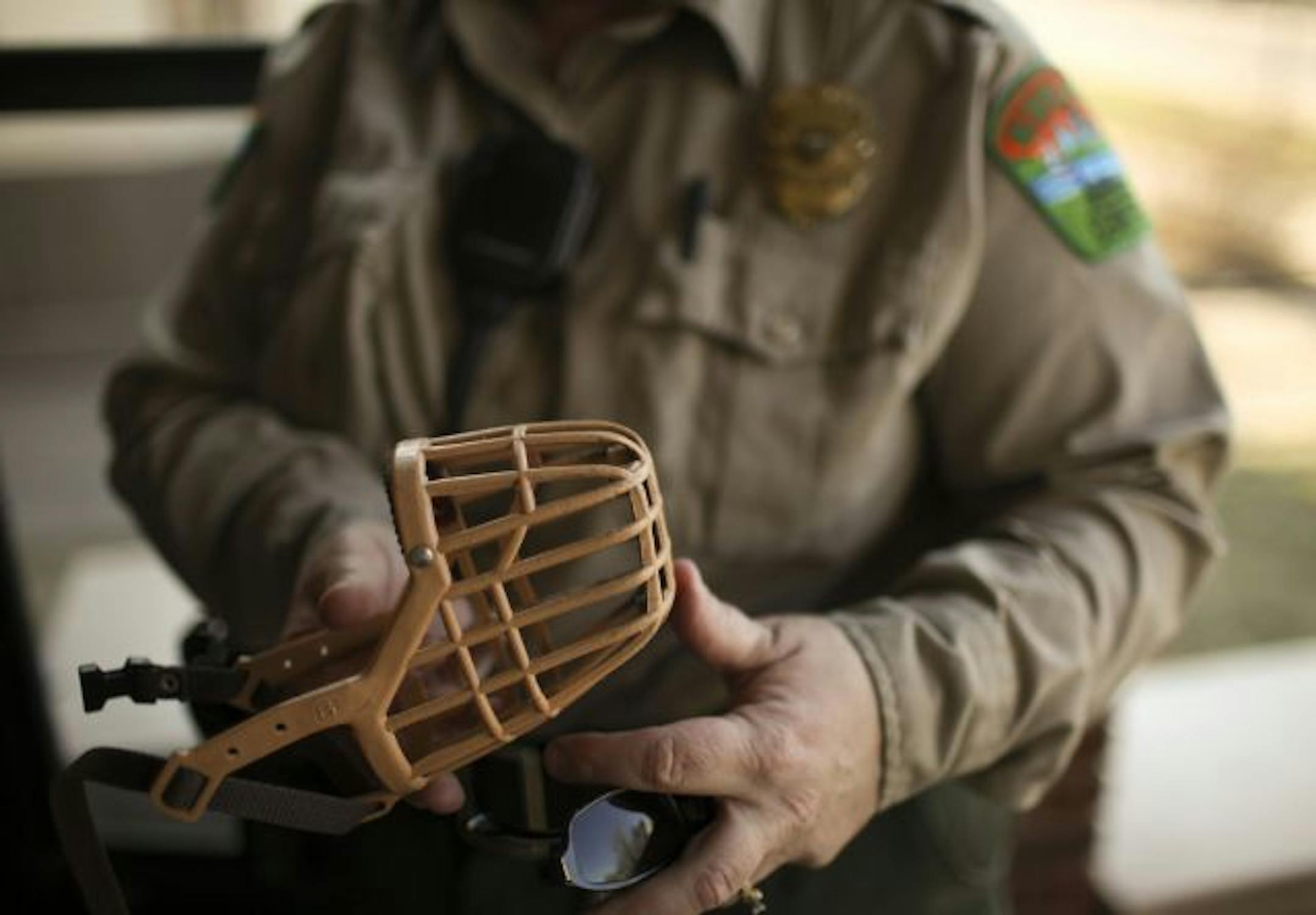 Annie Piper checked a potentially dangerous dog owner's muzzle for his animal during a compliance check Tuesday afternoon in Minneapolis. She thought he had the best muzzle available and was in full compliance.
