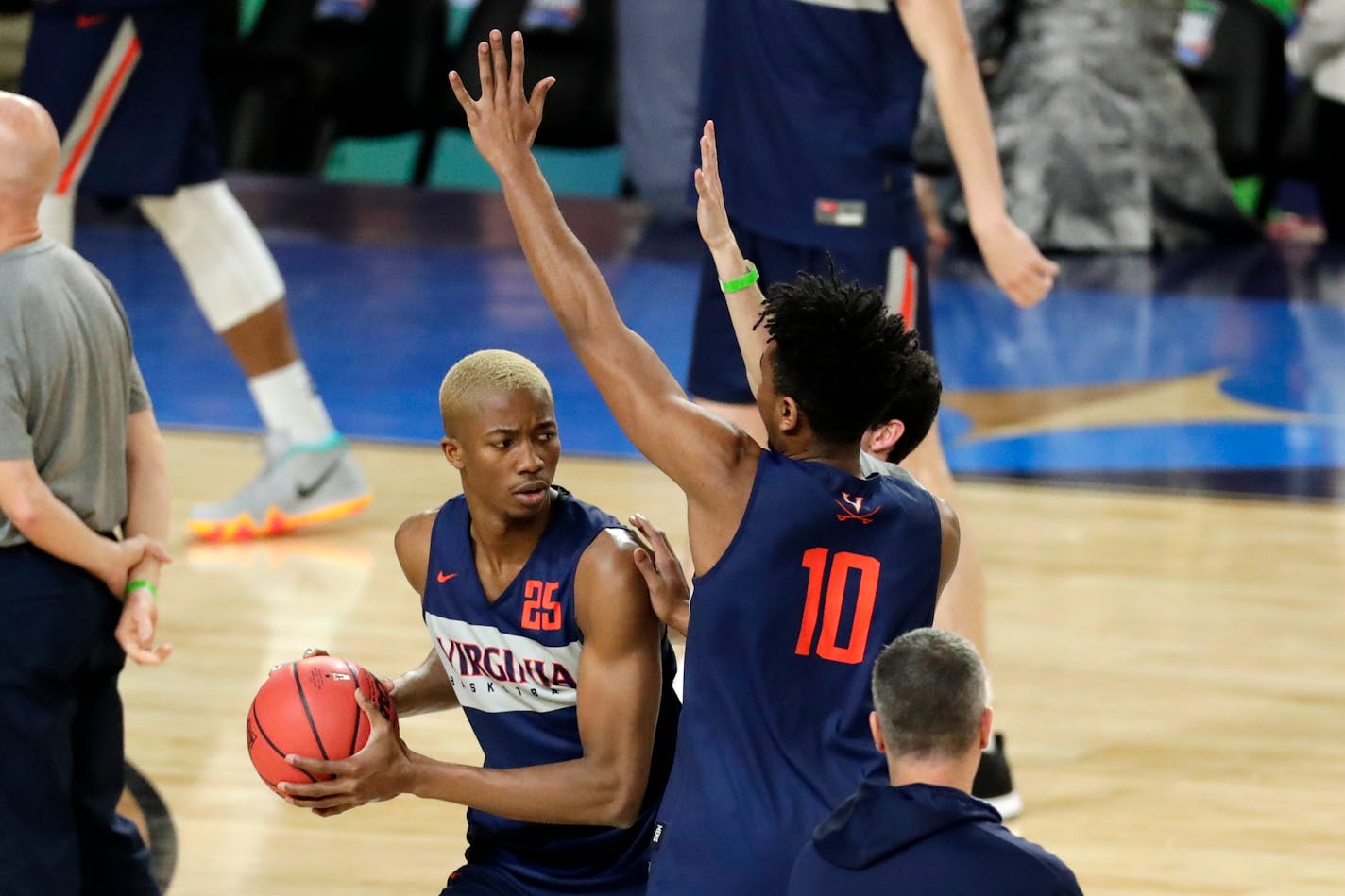 Virginia's Mamadi Diakite drives against the defense of teammate Jayden Nixon during a practice session