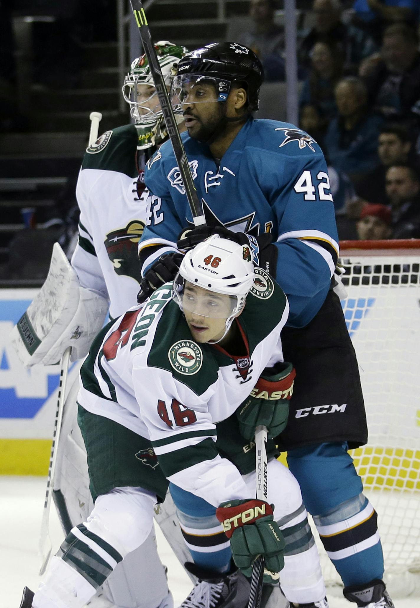 Minnesota Wild's Jared Spurgeon (46) goes against San Jose Sharks' Joel Ward during the first period of an NHL hockey game Saturday, Dec. 12, 2015, in San Jose, Calif. (AP Photo/Marcio Jose Sanchez)