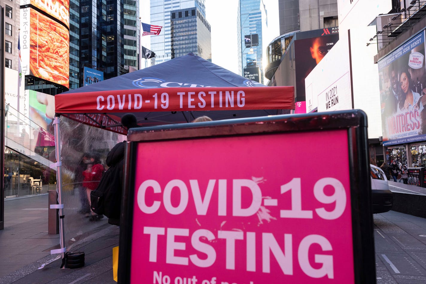 A sign of COVID-19 testing site is seen in Times Square on Friday, Dec. 3, 2021, in New York. The omicron variant of COVID-19, which had been undetected in the U.S. before the middle of this week, had been discovered in at least five states by the end of Thursday, showing yet again how mutations of the virus can circumnavigate the globe with speed and ease.(AP Photo/Yuki Iwamura)