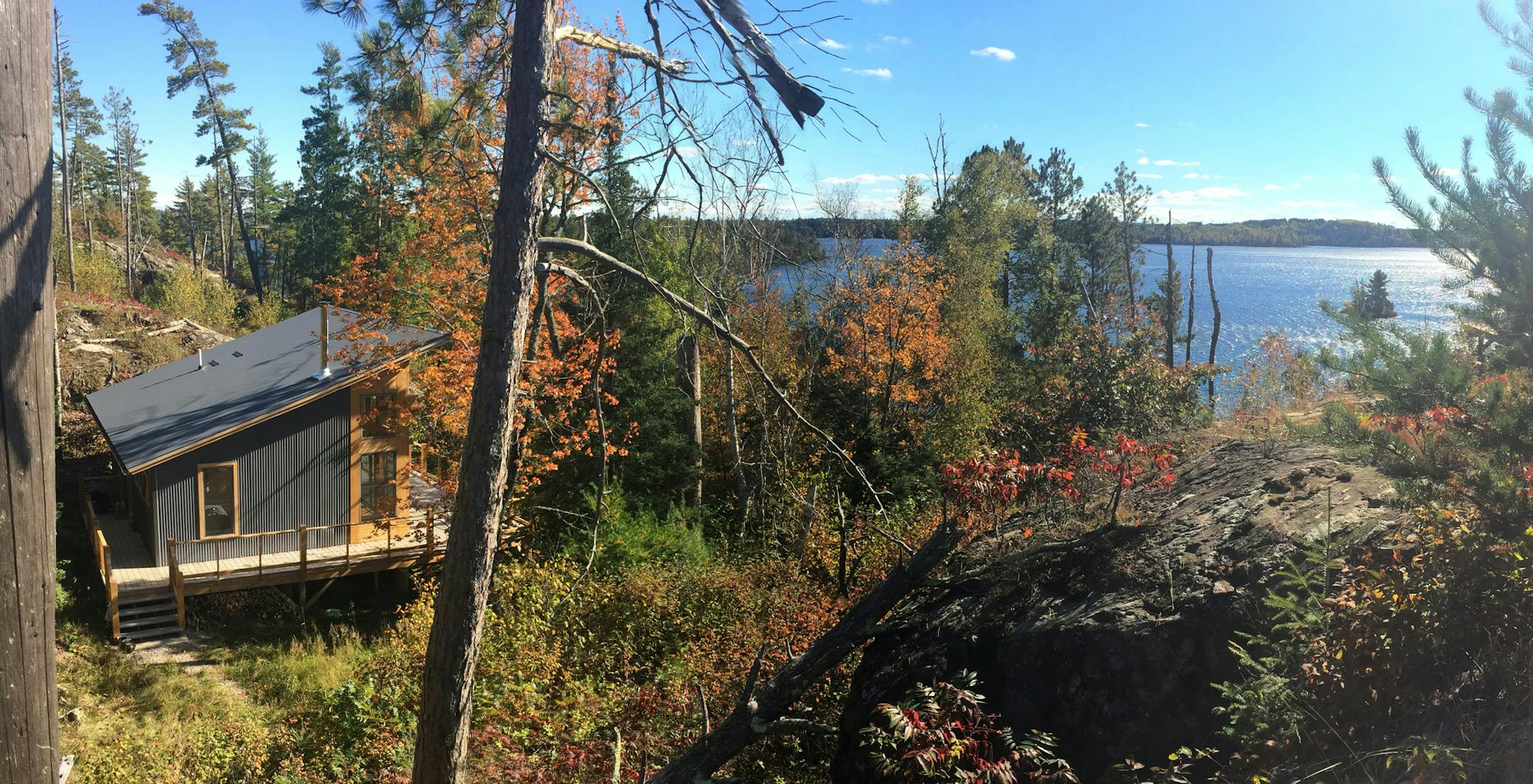 Ripple Island Cabin, a one-room cabin on Burntside Lake in northern Minnesota, mixes a classic pine interior with a corrugated metal exterior by architect Ken Stone.