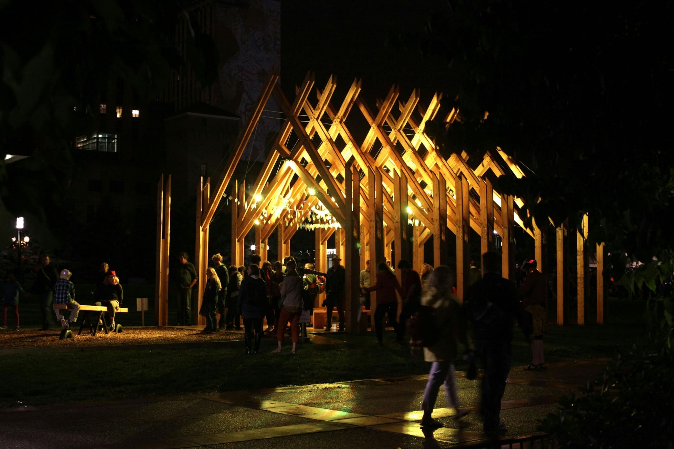 People walk through Balancing Ground, an interactive installation outside the Convention Center during Northern Spark on Saturday night.