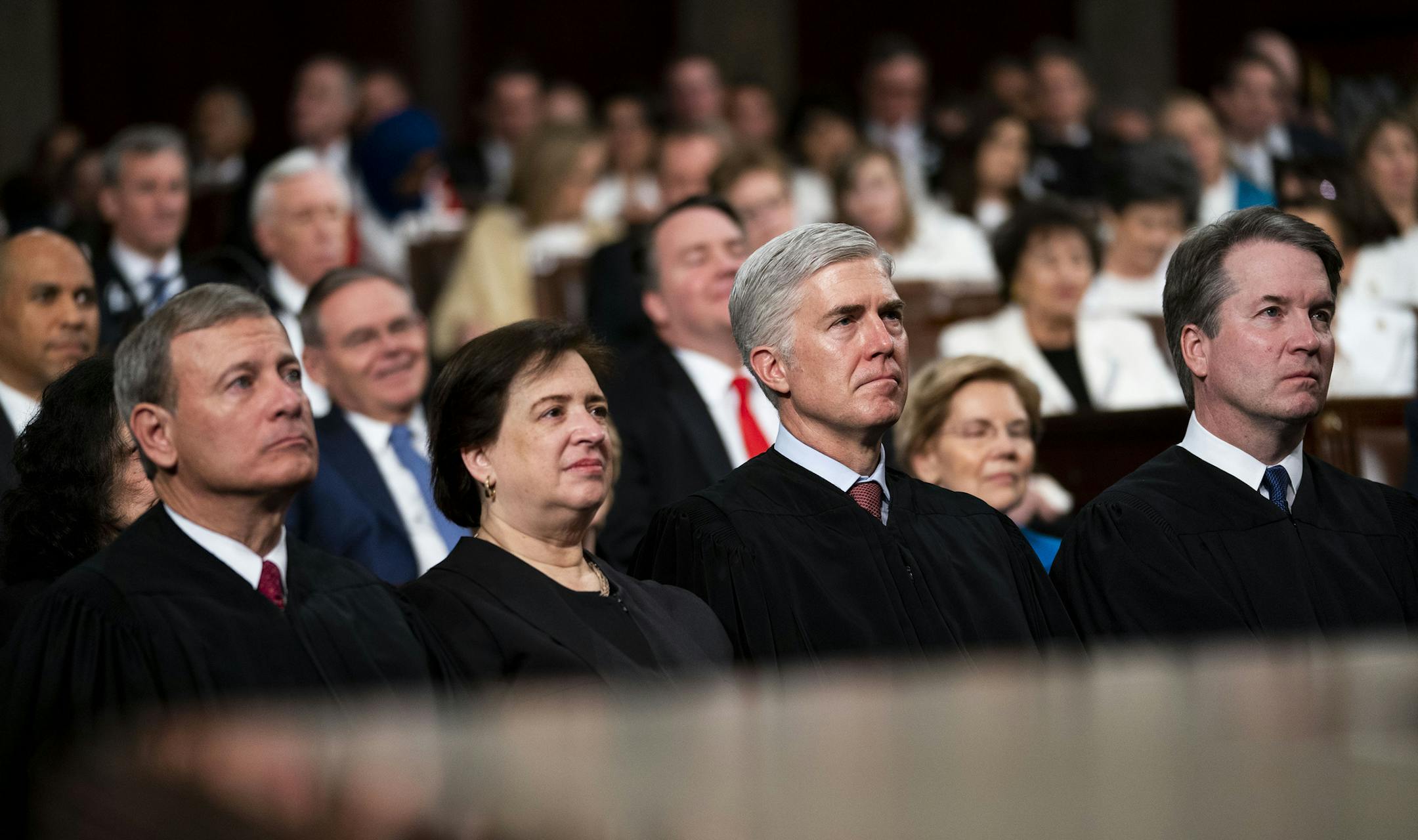 FILE -- From left: Supreme Court Chief Justice John Roberts, Associate Justice Elena Kagan, Associate Justice Neil Gorsuch and Associate Justice Brett Kavanaugh attend President Donald Trump's State of the Union address in Washington, Feb. 5, 2019. Several Supreme Court justices on May 13 continued a heated debate on how to handle last-minute requests in death penalty cases, issuing a series of unusual opinions about actions the court had taken several weeks ago. (Doug Mills/The New York Times)