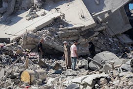 Palestinians sift through the rubble of their home in the wake of an Israeli air and ground offensive in Jebaliya, northern Gaza Strip after Israeli f