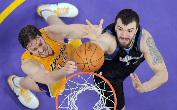 Minnesota Timberwolves center Nikola Pekovic, right, of Montenegro puts up a shot as Los Angeles Lakers forward Pau Gasol of Spain defends during the 