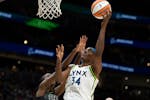 Minnesota Lynx center Sylvia Fowles, right, goes up for a shot against Seattle Storm center Ezi Magbegor during a WNBA basketball game, Friday, May 6,