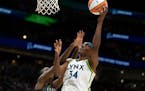 Minnesota Lynx center Sylvia Fowles, right, goes up for a shot against Seattle Storm center Ezi Magbegor during a WNBA basketball game, Friday, May 6,