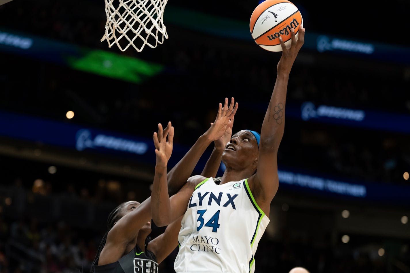 Minnesota Lynx center Sylvia Fowles, right, goes up for a shot against Seattle Storm center Ezi Magbegor during a WNBA basketball game, Friday, May 6, 2022, in Seattle. The Storm won 97-74. (AP Photo/Stephen Brashear)