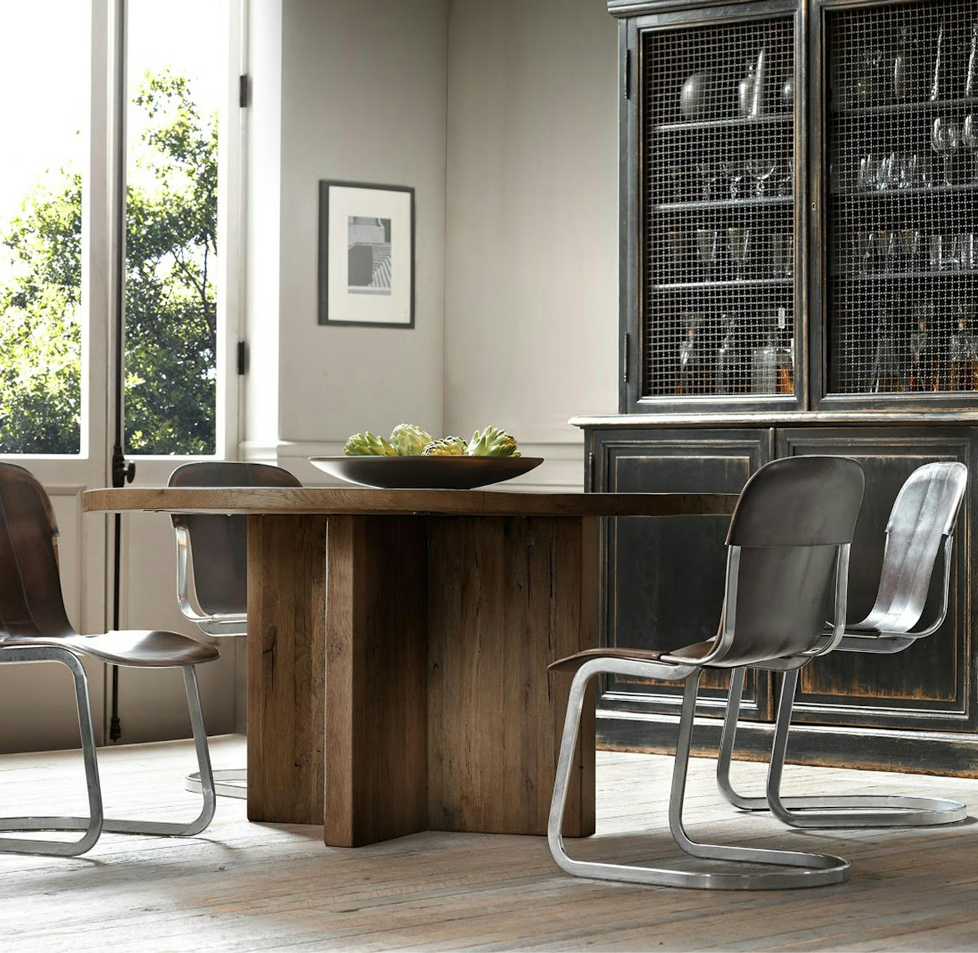 Rizzo Leather Side Chair by Restoration Hardware. The warmth of hand-distressed leather and the cool gleam of polished nickel play counterpoint in this chair inspired by mid-1970's Italian design. (TNS)