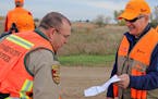 DNR conservation officer Lt. Gary Nordseth checked Gov. Dayton's license before the governor went afield on the first day of the 2017 ringneck season.