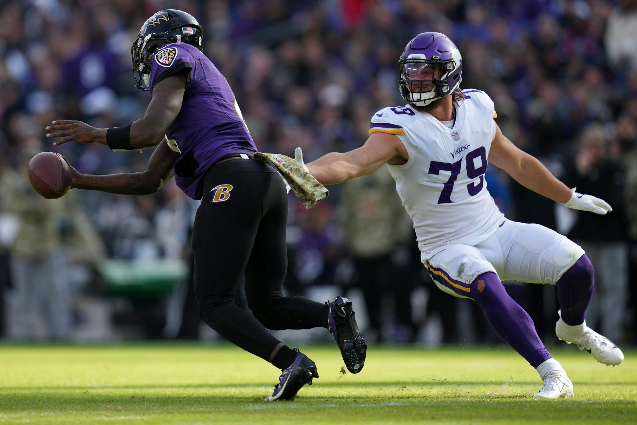 Vikings defensive end Kenny Willekes (79) was unable to get a hand on Ravens quarterback Lamar Jackson (8) as he rushed the ball in the second quarter.