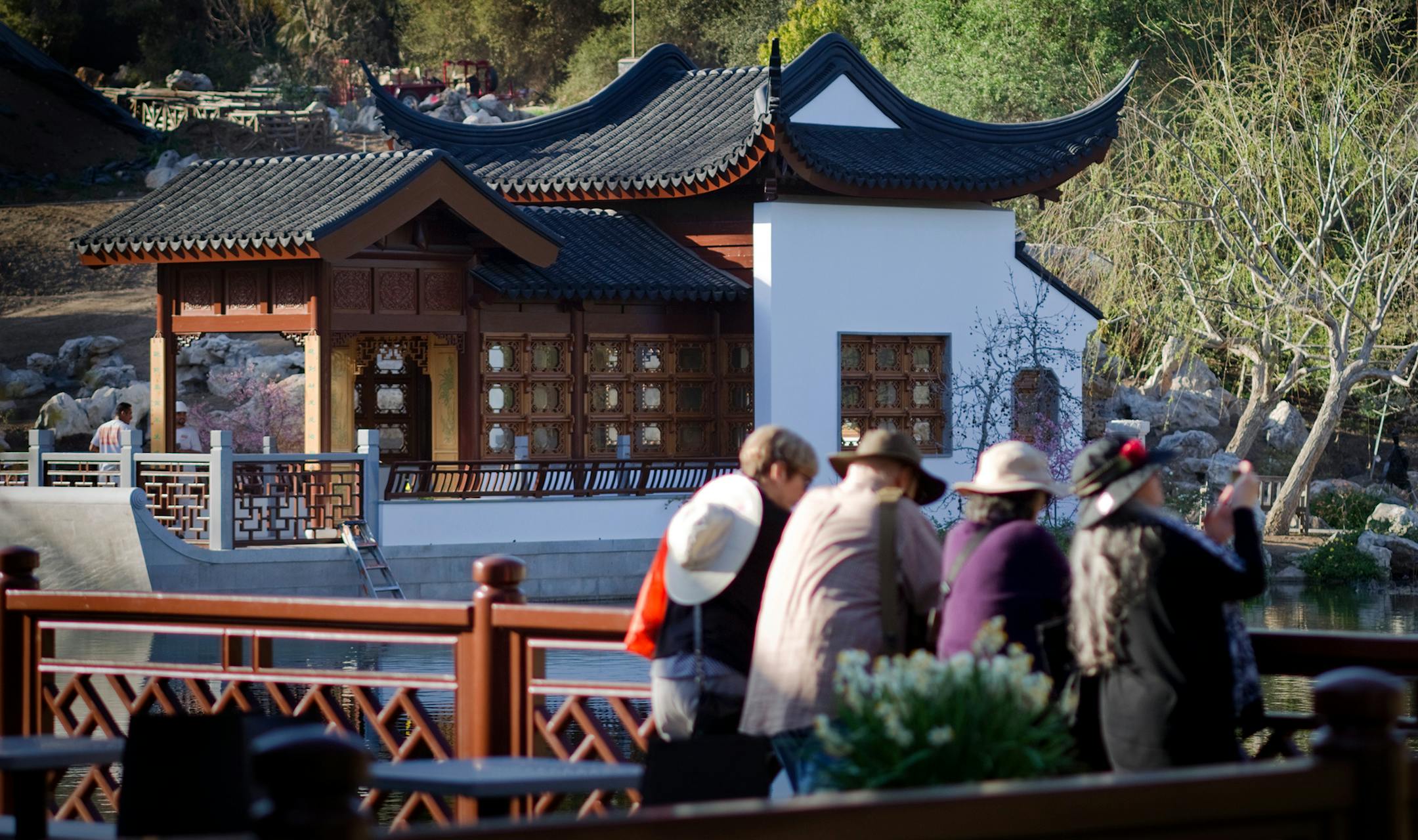 SAN MARINO, CA - FEBRUARY 19, 2014: Visitors enjoy the view of the newly completed Waveless Boat Pavilion on the west side of the Lake of Reflected Fragrance at the Huntington Chinese Garden on February 19, 2014 inside the Huntington Library, Art Collections, and Botanical Gardens in San Marino, California. The pavilion is part of the second phase of the Chinese garden which opens in early March.(Gina Ferazzi / Los Angeles Times/TNS) ORG XMIT: 1455225