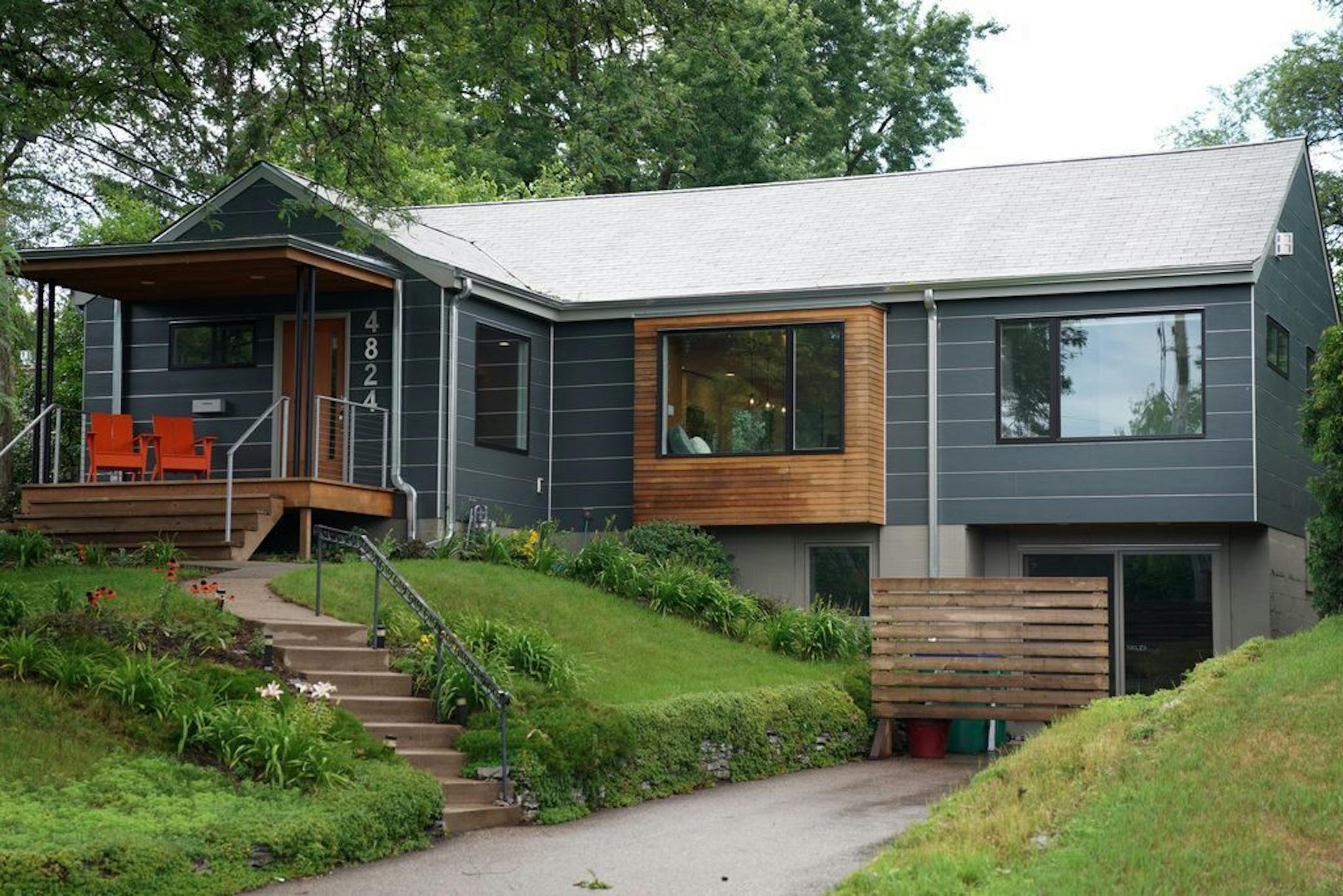 The 1950s home's new 21st-century look includes a front entry porch, cedar-clad bay bumpout and tuckunder garage-turned "kids zone." Designed by Eric Odor, SALA Architects.