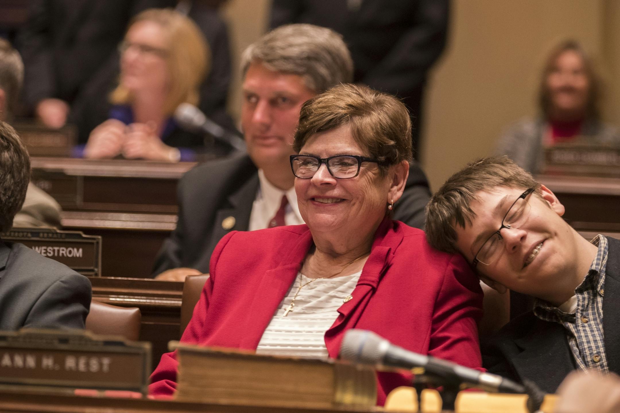 Sen. Ann Rest, DFL-New Hope, sits with her grandson Jonas Asplund, 14, of Woodbury during the session in the Minnesota Senate chambers.