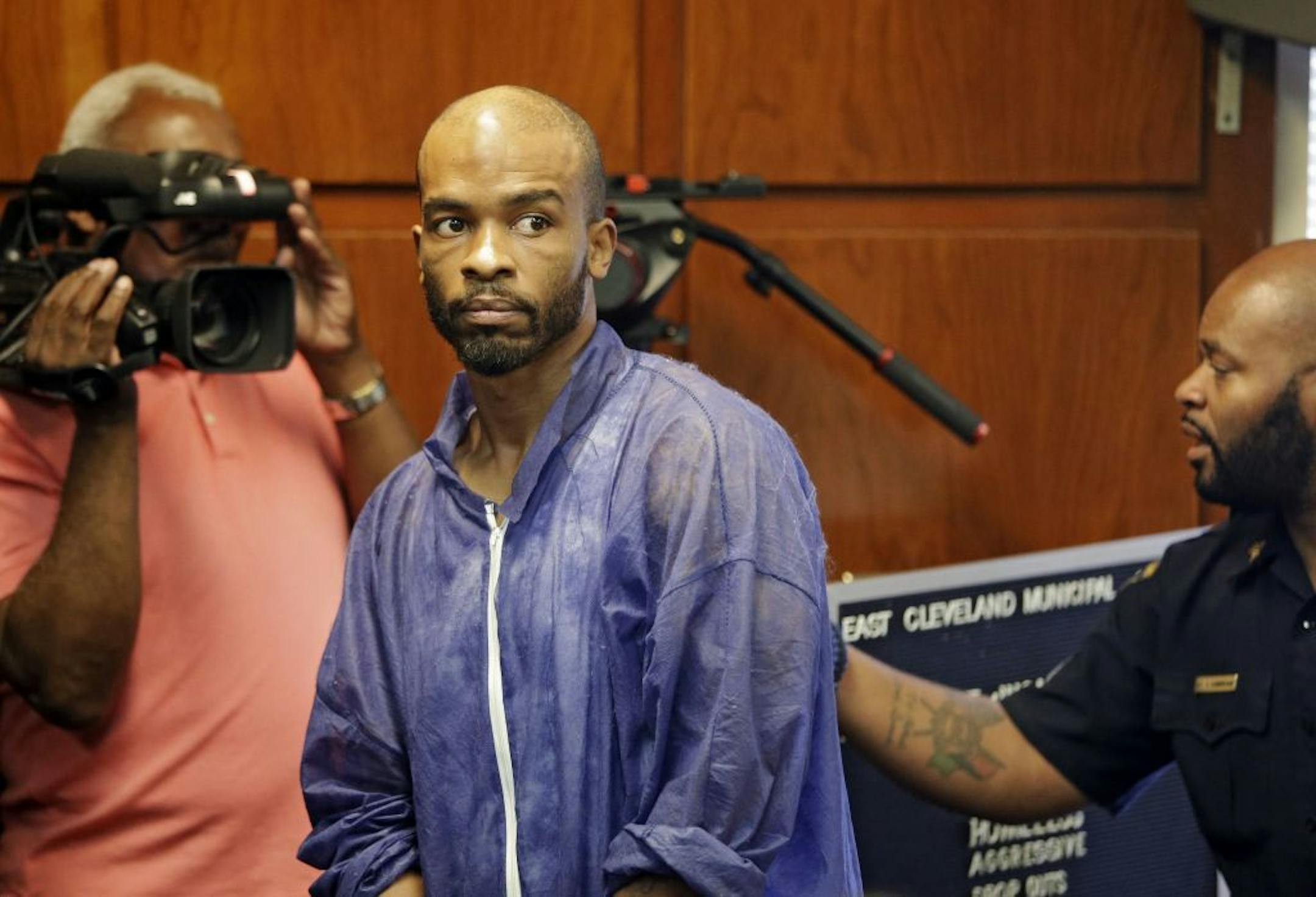 Michael Madison is brought into court for his arraignment in East Cleveland, Ohio on Monday, July 22, 2013. Madison is charged with aggravated murder in the deaths of three women found in garbage bags in the city over the weekend.
