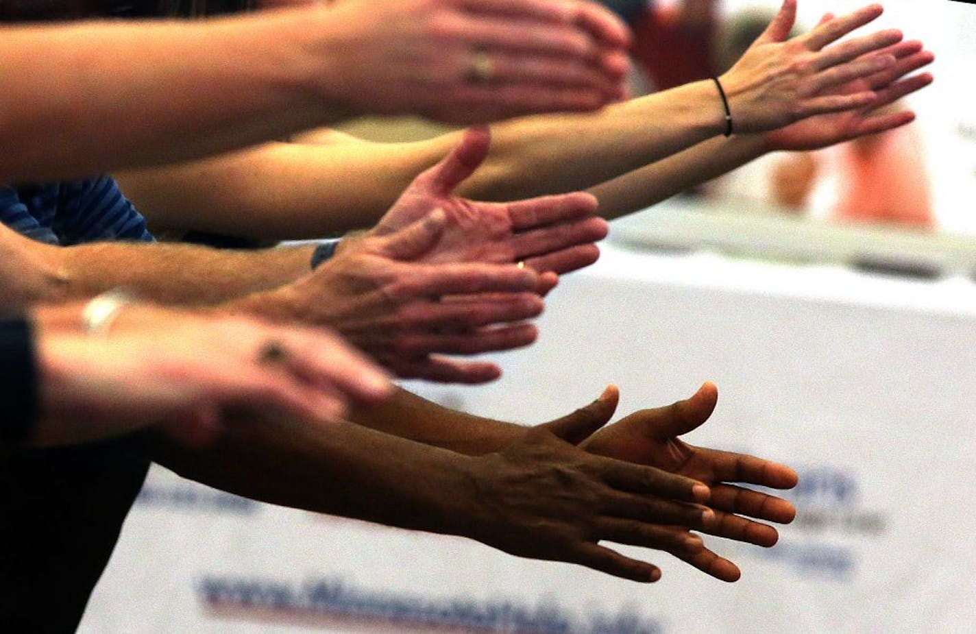 Adults participated in a Tai Ji Quan: Moving for Better Balance class taught by Dr. Fuzhong Li (not pictured) at the "Take a Stand to Prevent Falls" event held at the National Guard Armory in St. Paul.