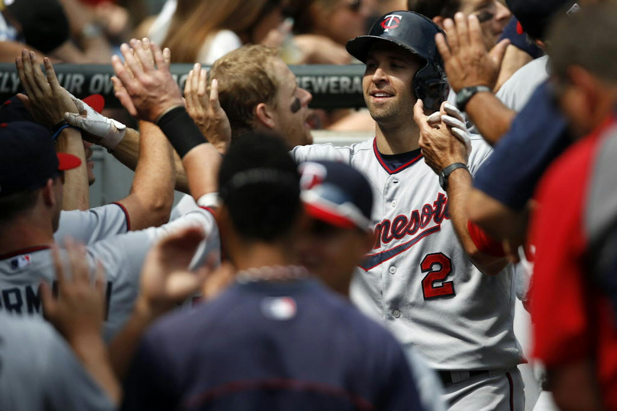 Minnesota's Brian Dozier (2) heads into the dugout after hitting a three-run home run against the Chicago White Sox during the fifth inning Sunday.
