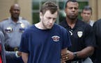Kenneth James Gleason is escorted by police to a waiting police car in Baton Rouge, La., Tuesday, Sept. 19, 2017. Gleason is charged with two counts o