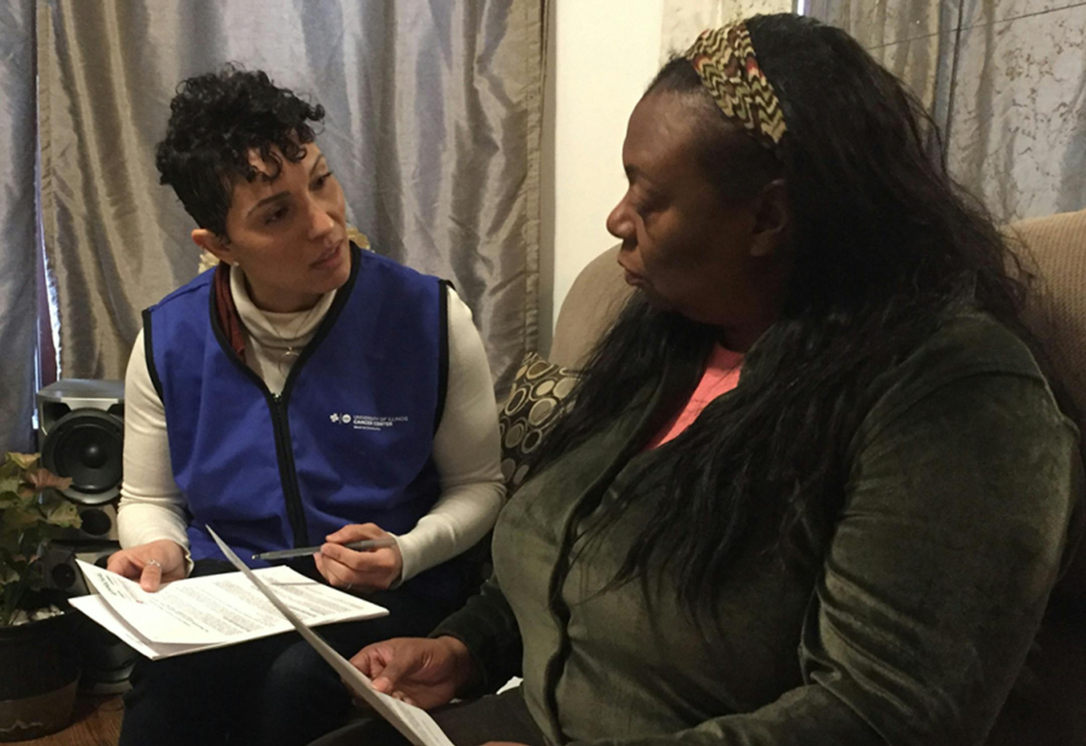 Dr. Kathy Tossas-Milligan (left), an epidemiologist with the University of Illinois? at Chicago, interviews Yolanda Flowers as part of a pilot project to study the high infant mortality rate in Chicago's Englewood neighborhood. (Miles Bryan/WBEZ)