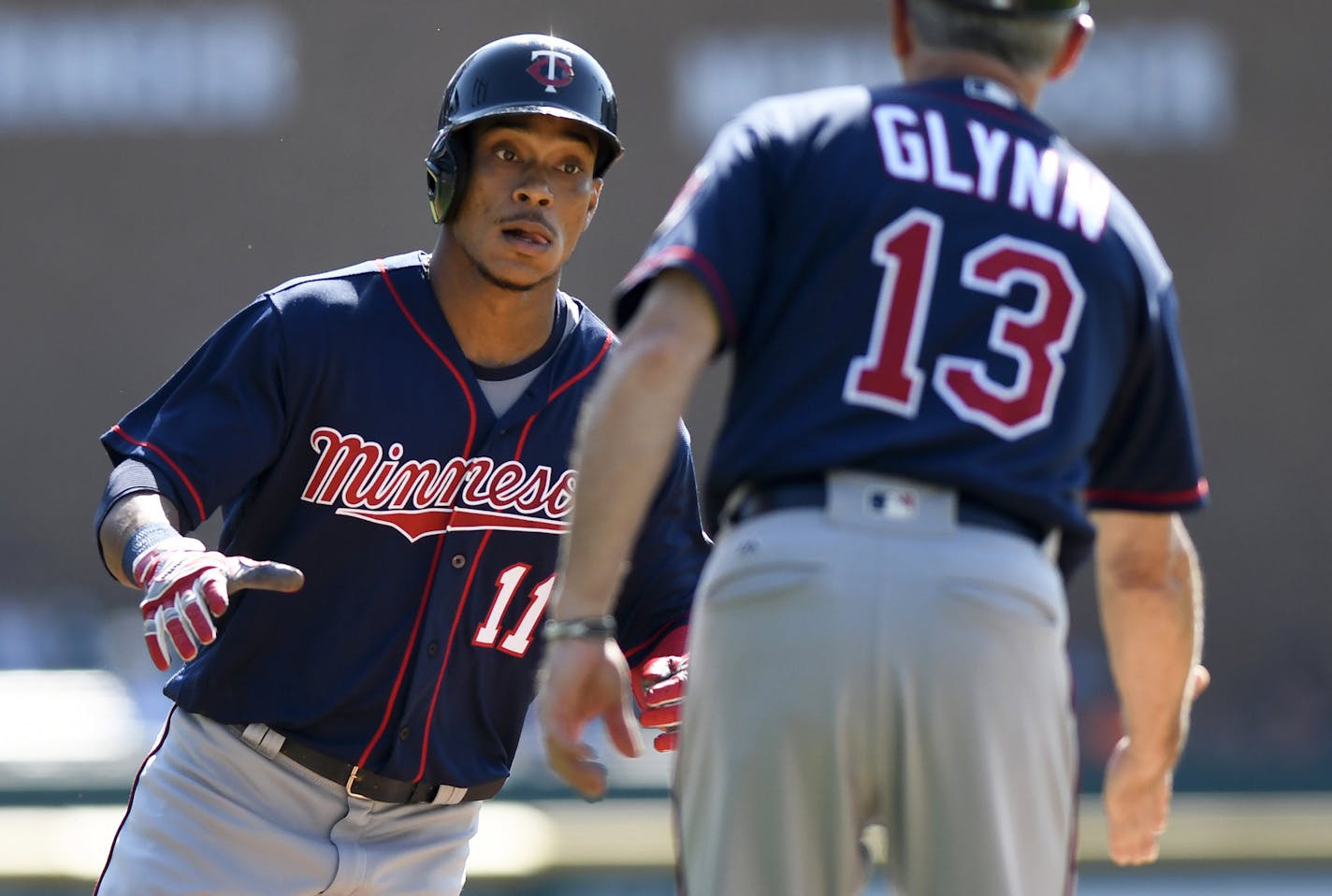 Minnesota Twins' Jorge Polanco (11) is congratulated by third base coach Gene Glynn (13) after hitting a home run during the first inning of a baseball game against the Detroit Tigers, Sunday, Sept. 24, 2017, in Detroit. (AP Photo/Jose Juarez)