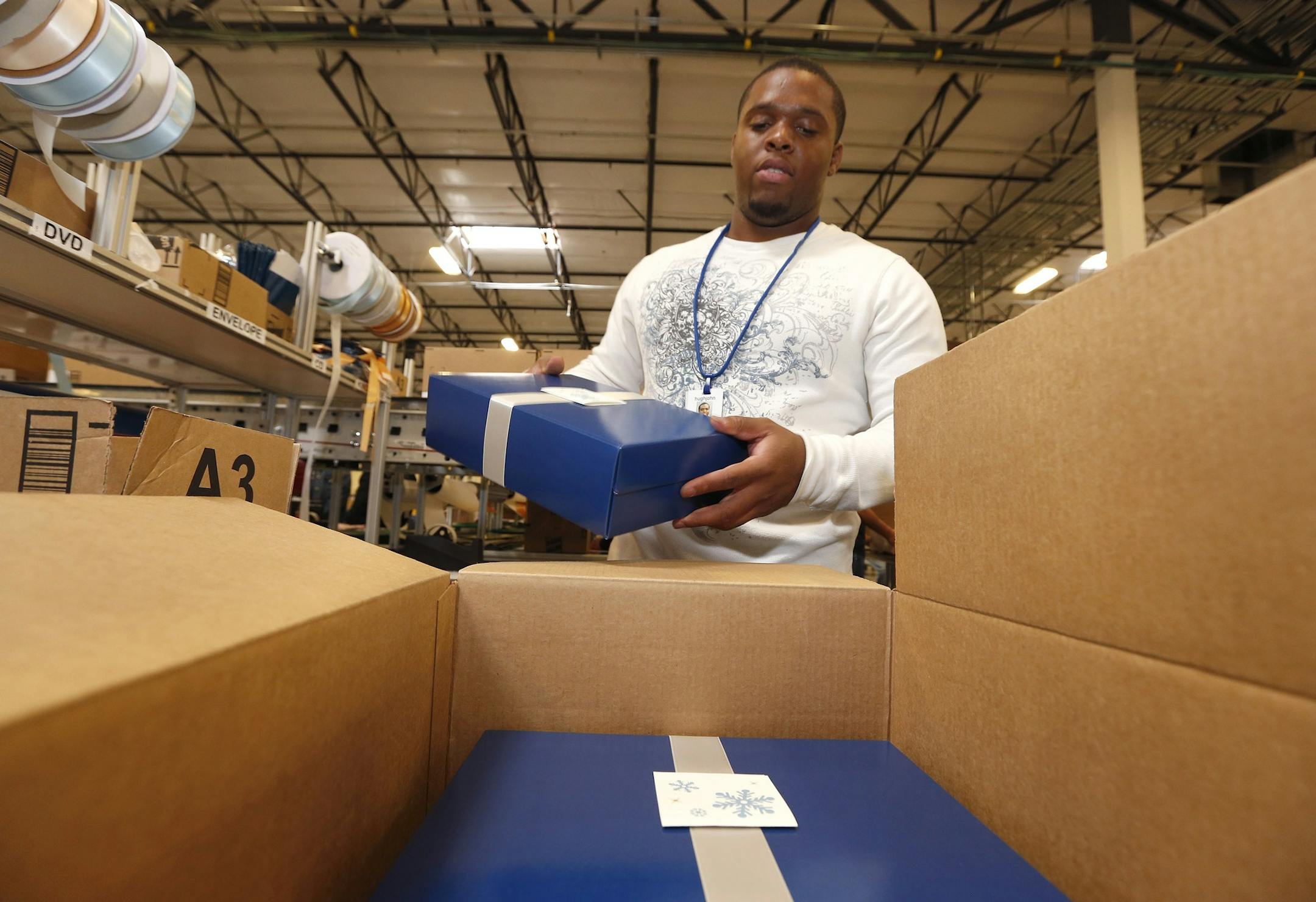 Amazon.com employee Hugh Johnson, Jr., packs up a box after finishing some custom wrapping at an Amazon.com Fulfillment Center on "Cyber Monday" on the busiest online shopping day of the holiday season Monday, Dec. 2, 2013, in Phoenix. (AP Photo/Ross D. Franklin)