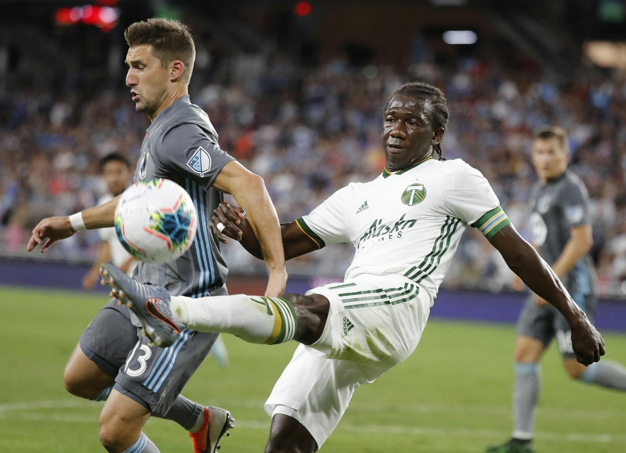 Minnesota United midfielder Ethan Finlay (13) and Portland Timbers midfielder Diego Chara (21) battled during the second half.