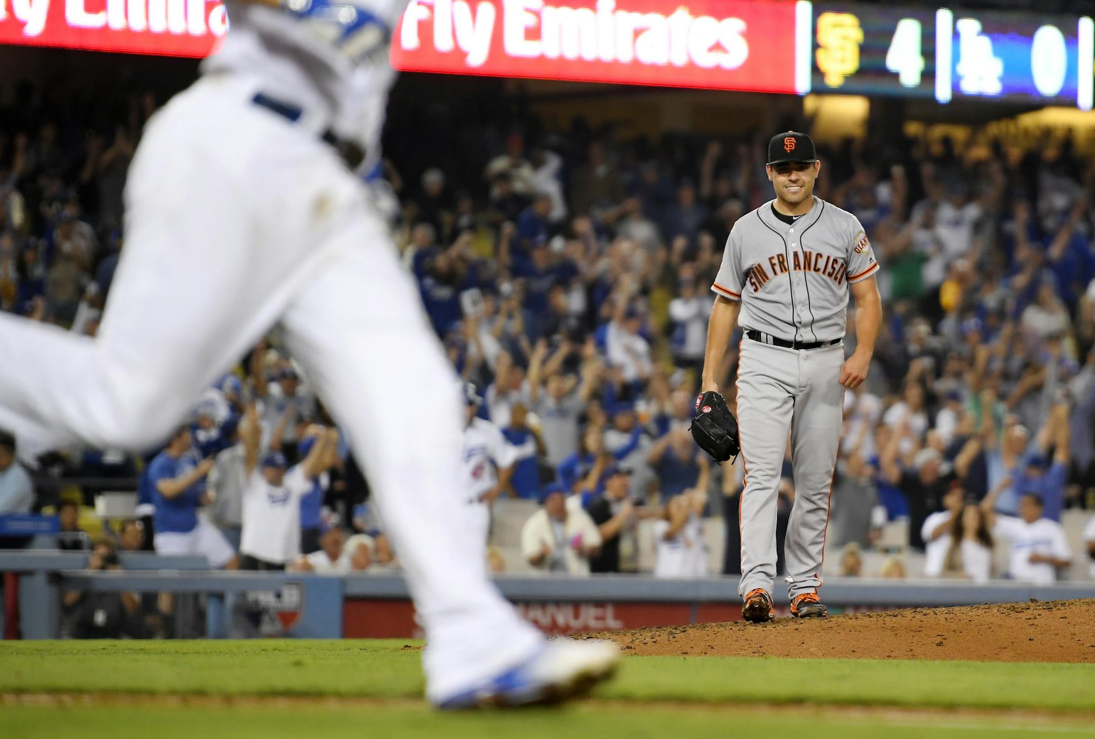 San Francisco Giants starting pitcher Matt Moore, right, looks toward first as Los Angeles Dodgers' Corey Seager runs after Seager broke up his no-hitter with two outs in the ninth inning of a baseball game, Thursday, Aug. 25, 2016, in Los Angeles. The Giants won 4-0. (AP Photo/Mark J. Terrill)