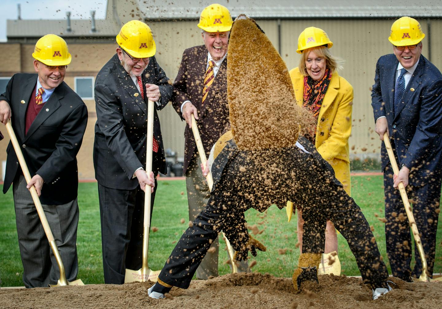 Goldie Gopher, tail flying, showed off digging skills Friday during groundbreaking for the new Athletes Village at the University of Minnesota. It was a lighter moment for, Dean Johnson, left, Eric Kaler, John Lindahl, Nancy Lindahl and Chris Policinski.